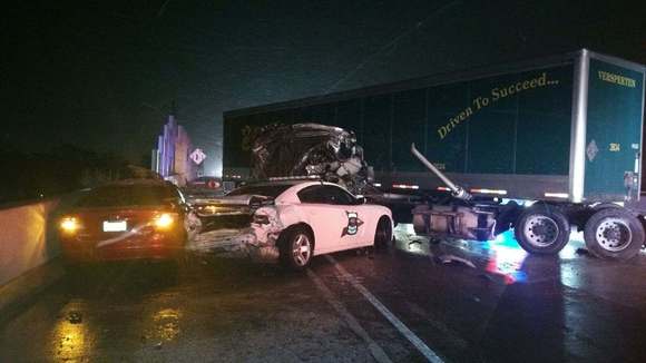 tractor trailer hits police car